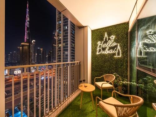 a balcony with a view of the city at night at Stunning Two-Bedroom Apartment with Skyline View & walk to Dubai Mall by TerraHome in Dubai