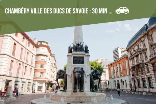 a statue in the middle of a city street at Le Relai Du Val -Wifi Terrasse in Châteauneuf