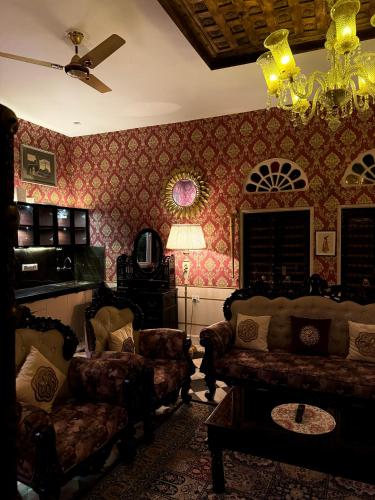 a living room with a couch and chairs at Bhanpur Haveli in Dhānd