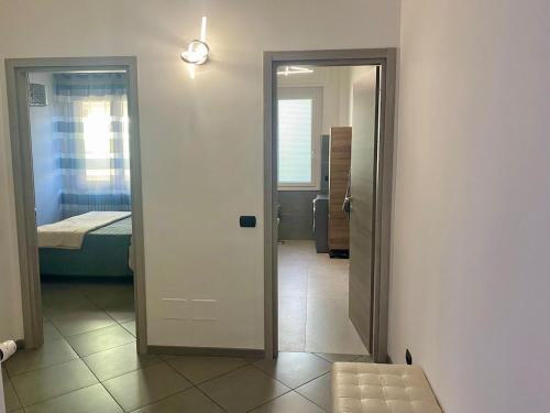 a hallway with a door leading to a bedroom at MM HOUSE Lainate modern design near Rho Fiera in Lainate