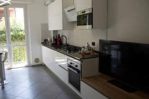 a kitchen with a stove and a counter top at MM HOUSE Lainate modern design near Rho Fiera in Lainate