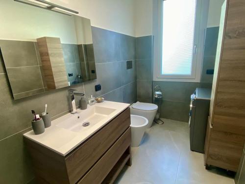 a bathroom with a sink and a toilet at MM HOUSE Lainate modern design near Rho Fiera in Lainate