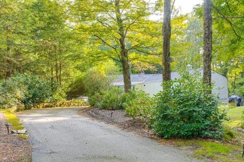 a driveway leading to a house with trees at Near Main St and Festivals Peaceful Keene Getaway! in Keene