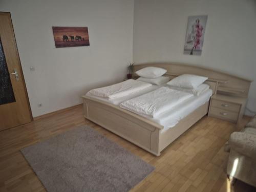a bedroom with a bed with white sheets and pillows at Ferienhaus Sofia in Cochem