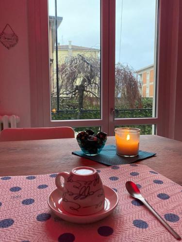 a table with a tea pot and a candle on it at MM HOUSE Lainate modern design near Rho Fiera in Lainate