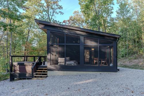 a black tiny house on a gravel lot at The Briar House in McArthur