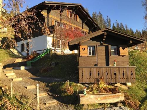a house with a wooden fence in front of it at Datscha in Lenk