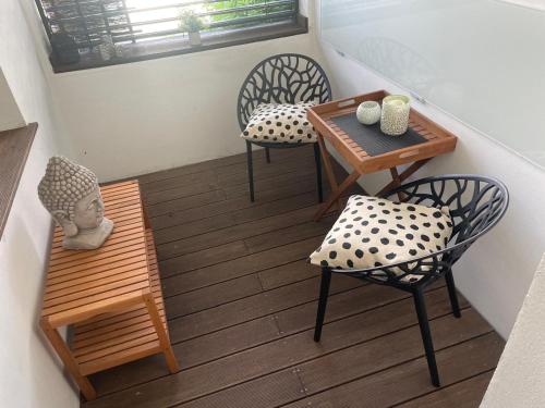 a small balcony with chairs and a table and a table and chairs at WohnRaum Gäste- & Boardinghaus in Gusterath