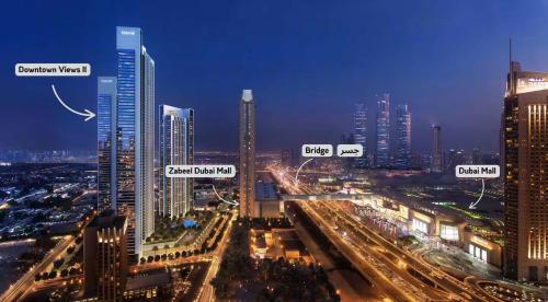 a city skyline at night with many tall buildings at Stunning Two-Bedroom Apartment with Skyline View & walk to Dubai Mall by TerraHome in Dubai
