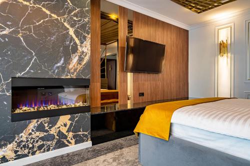 a hotel room with a fireplace and a bed at PRESTIGE PLAZA in Suceava