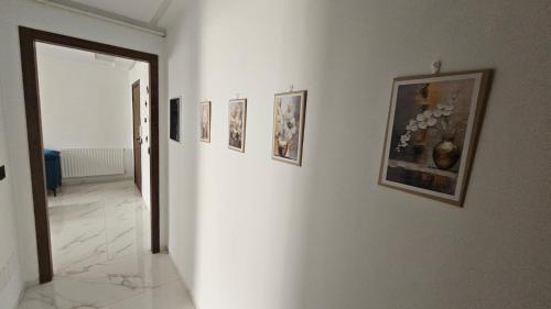 a hallway with pictures on the walls of a room at حي الواحات in Tunis