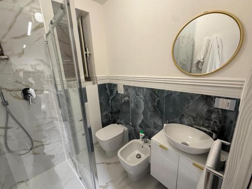 a bathroom with a toilet and a sink and a mirror at Holiday Home - Si Do Relais in Pozzuoli