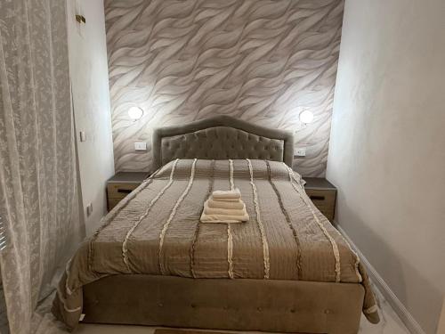 a bedroom with a bed with a blanket on it at Holiday Home - Si Do Relais in Pozzuoli