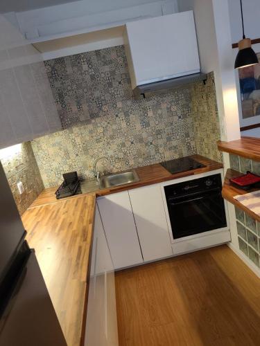 a kitchen with a sink and a stove at Atlantis Azor in Angra do Heroísmo