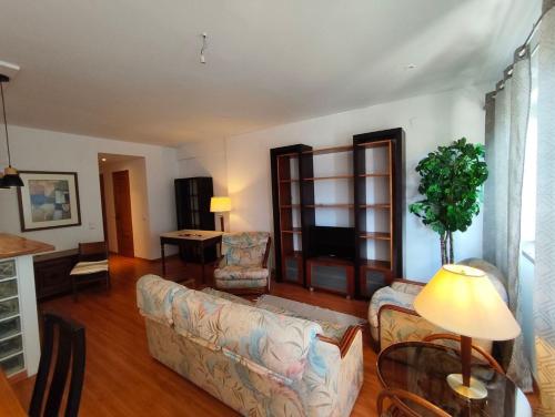 a living room with a couch and a tv at Atlantis Azor in Angra do Heroísmo
