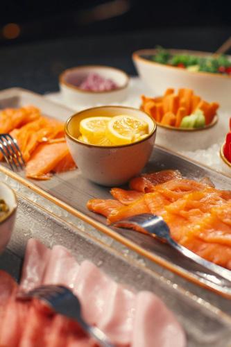 a tray of food with a bowl of lemon slices at Tbilisi Marriott Hotel in Tbilisi City