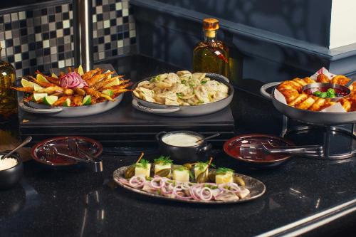 a table with three plates of food on a counter at Tbilisi Marriott Hotel in Tbilisi City