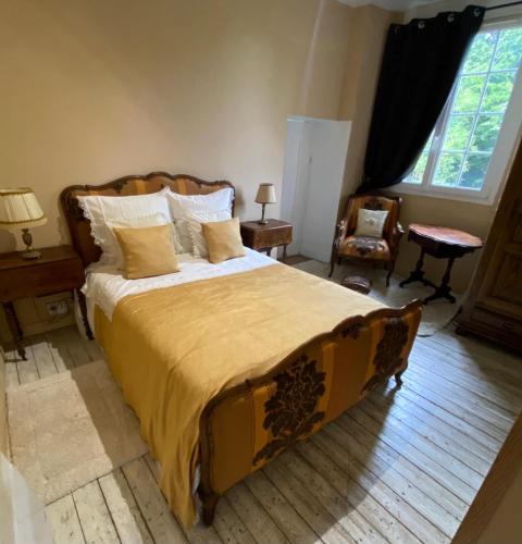 a bedroom with a large bed and a chair at Grandes Molaises in Les Hogues