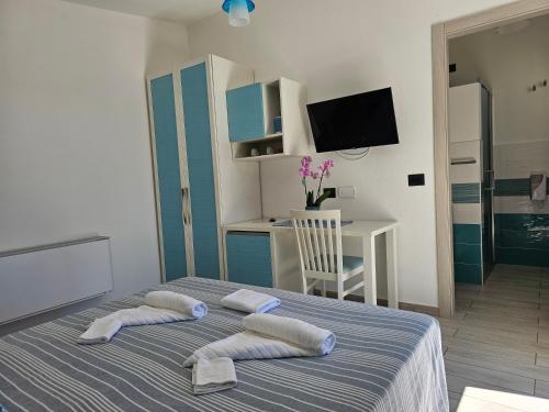 a bedroom with a bed with two pillows on it at Hotel Pranos Turismo Rurale Cala Gonone in Cala Gonone