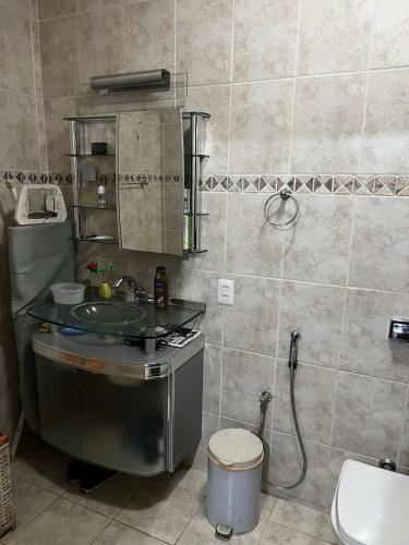 a bathroom with a sink and a shower and a toilet at The grey house centrally located in Campinas