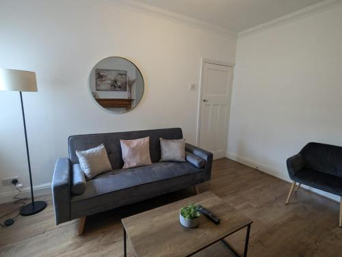 a living room with a couch and a table at AA Exec Apartments in South Shields