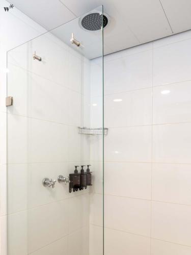 a shower with a glass door in a bathroom at Hotel Santa Ana Medellin in Medellín