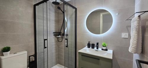 a bathroom with a shower and a sink and a mirror at Apartment Oceana - Luxury Sea View Beach Apartment in Calpe