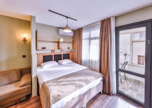 a bedroom with a large bed and a window at Peaceful Apartment Near Galata in Istanbul