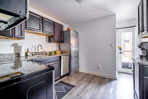 a kitchen with stainless steel appliances and wooden floors at Short North Convention Private Parking Pets in Columbus