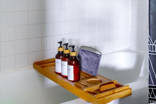 a wooden shelf in a bathroom with bottles on it at Short North Convention Private Parking Pets in Columbus