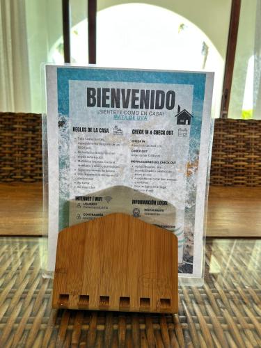a sign sitting on top of a wooden floor at Beachfront house Private beach Pool 6 people in El Zapote