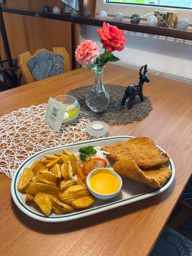 a plate of food with french toast and french fries at M1 Laczházy Hotel Coffee & More in Mocsa
