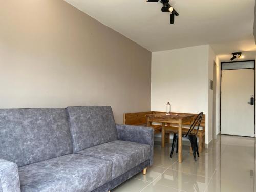 a living room with a couch and a table at Hotel Santa Ana Medellin in Medellín
