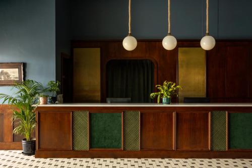 a reception desk with a mirror and potted plants at Portrush Atlantic Hotel in Portrush