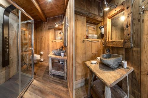 a bathroom with two sinks and a shower at Brieis Relais Alpino in Marmora