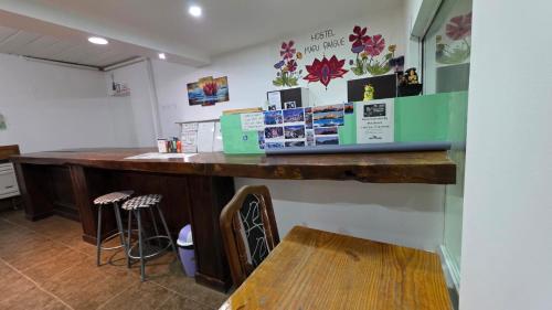 un bar en una habitación con una mesa y un banco en Hostel Mapu Paigue, en El Chaltén