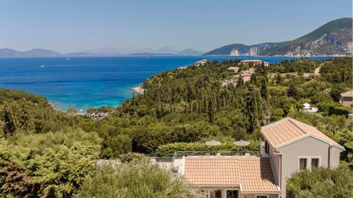 a house on a hill with a view of the ocean at Ruggero by Vintage Travel in Psilithriás