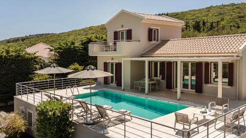a villa with a swimming pool and a house at Ruggero by Vintage Travel in Psilithriás