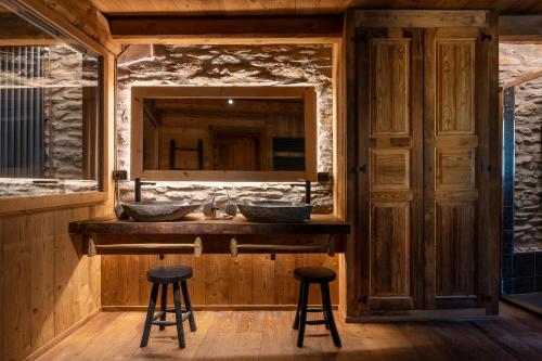 a bathroom with two sinks and a mirror at Brieis Relais Alpino in Marmora