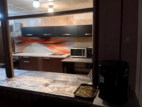 a kitchen with a counter top with a microwave at Бунгала Виктори Victory Bungalows in Shkorpilovtsi