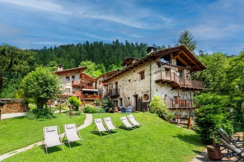 a group of lawn chairs in front of a house at Brieis Relais Alpino in Marmora