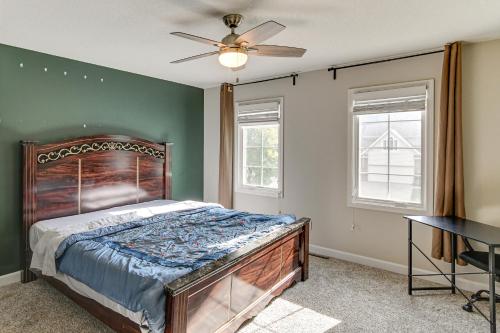 Un dormitorio con una cama y un ventilador de techo. en Des Moines Suburb Stay with Spacious Layout and Deck!, en Johnston