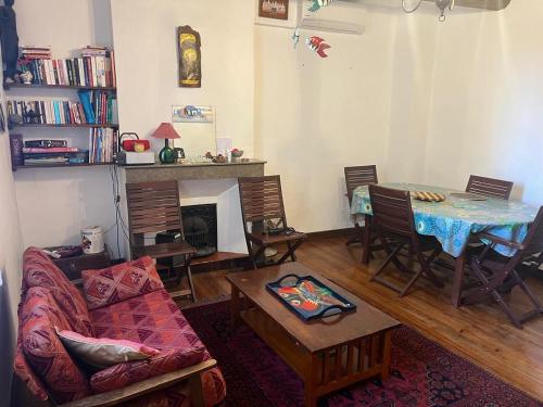 a living room with a couch and a table at Une chambre à louer dans une maison au centre ville Uzes in Uzès