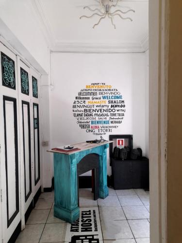 a blue table in a room with a wall at Atacama Hostel Backpackers in Santiago