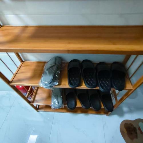 a shelf with a bunch of shoes on it at Book and Bed-People's Square in Shanghai