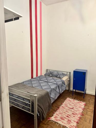 two beds in a room with an american flag painted on the wall at Barão 35 Guest House in Braga