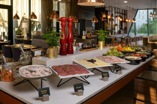 a buffet line with different types of food on display at Courtyard by Marriott Vilnius City Center in Vilnius