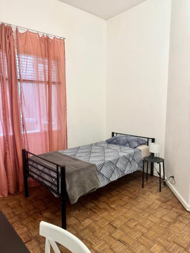 a bedroom with a bed and a window at Barão 35 Guest House in Braga