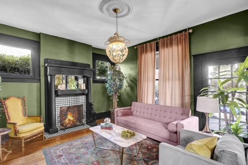 a living room with a pink couch and a fireplace at Cozy Casa Mina 1br Near Downtown Parking in El Paso