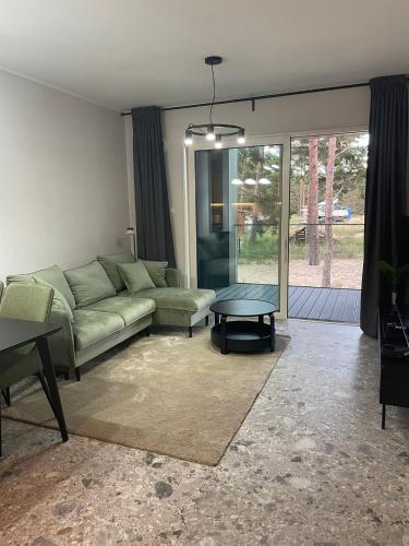 a living room with a couch and a table at Czarna Perła Hel in Hel